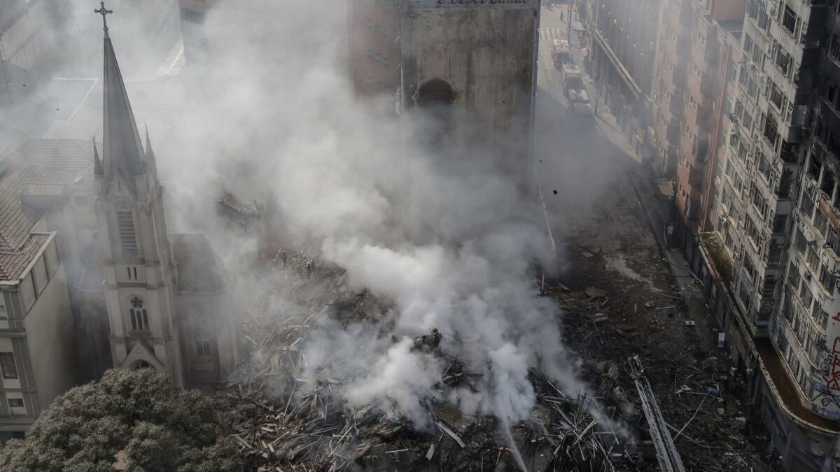 The debris of a collapsed building smolders in Sao Paulo.