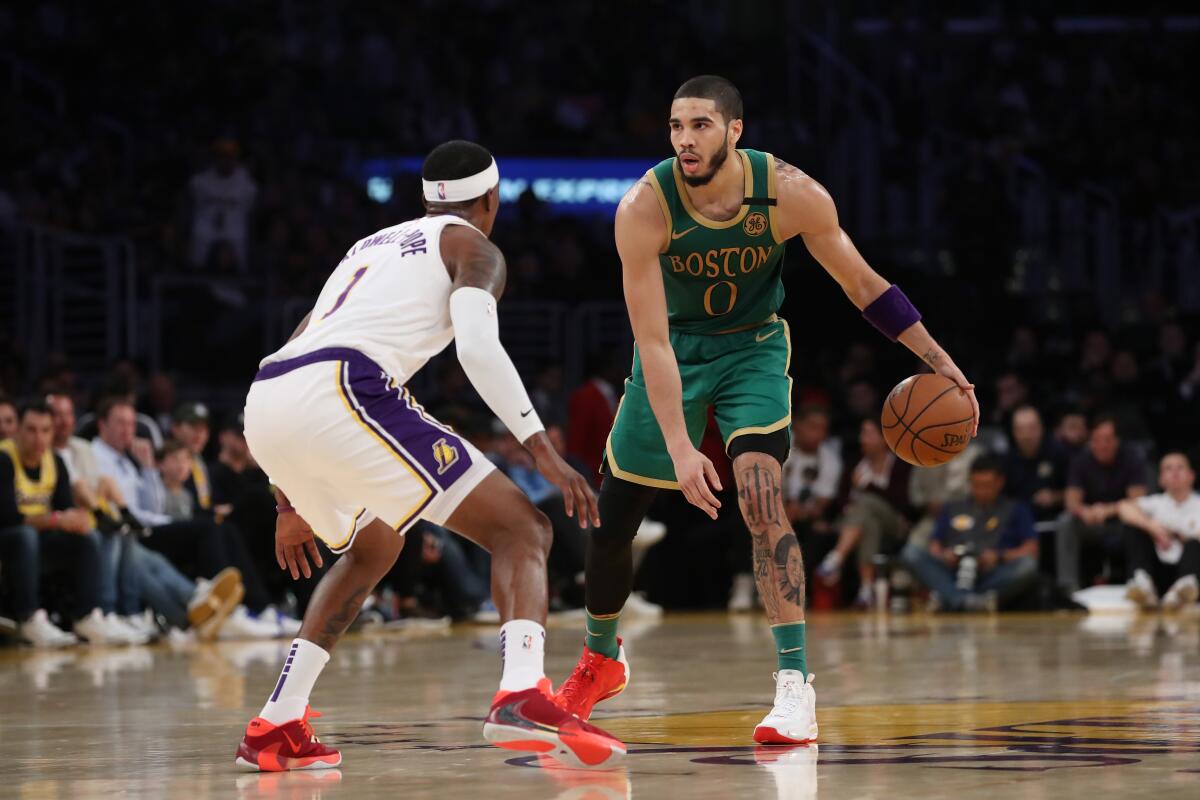 Celtics forward Jayson Tatum sets up the offense while guarded by Lakers guard Kentavious Caldwell-Pope on Feb. 22 at Staples Center.