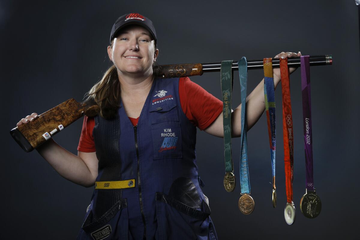 Double trap and skeet shooter Kim Rhode poses for photos with her Olympic medals at the 2016 Team USA media summit in Beverly Hills on March 8, 2016.