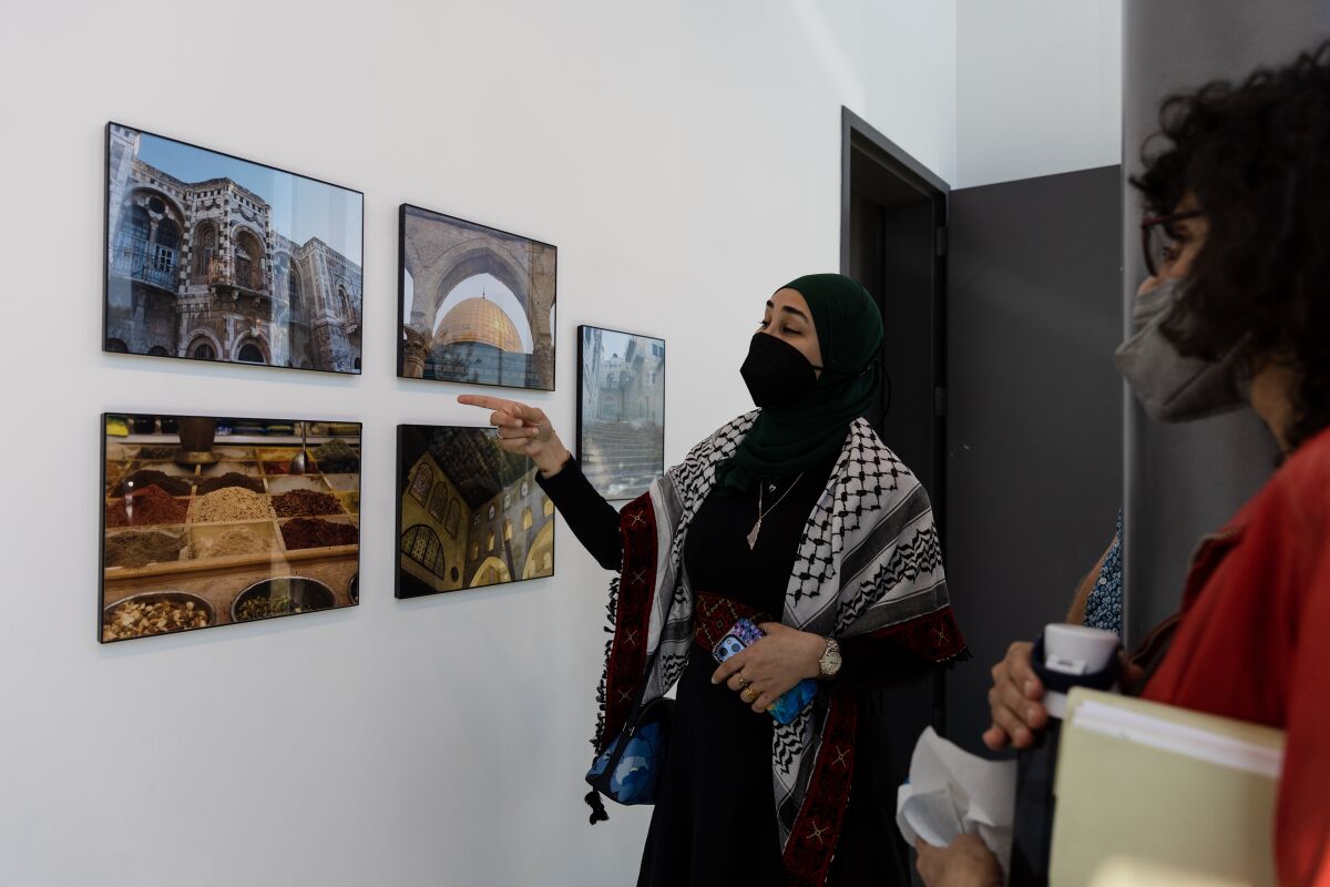 Artist Haneen Oriqat discusses her photos at Hyde Art Gallery at Grossmont College.