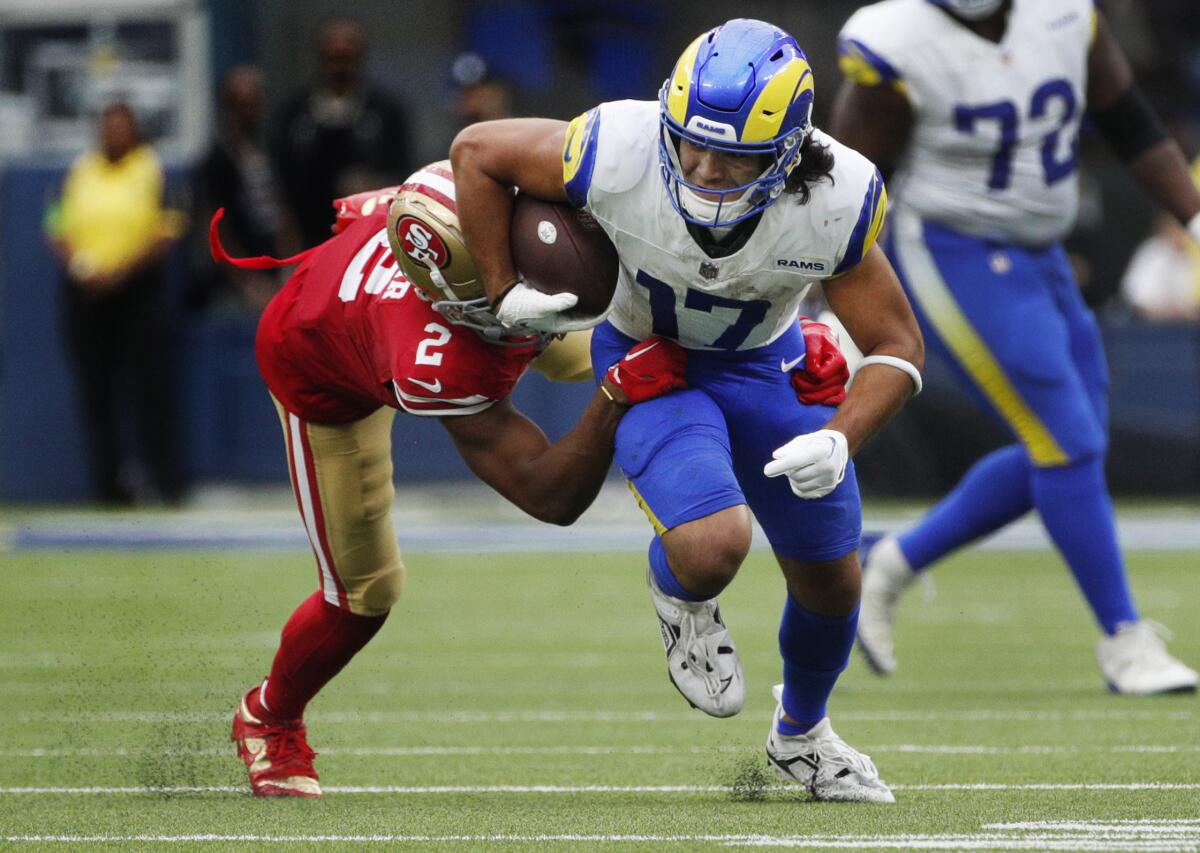 Rams wide receiver Puka Nacua tries to run past San Francisco 49ers cornerback Deommodore Lenoir.