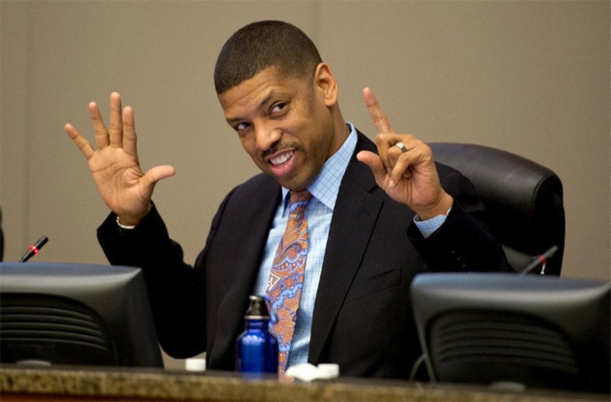 Sacramento Mayor Kevin Johnson counts the votes in favor of the new arena on his fingers during a city council meeting.