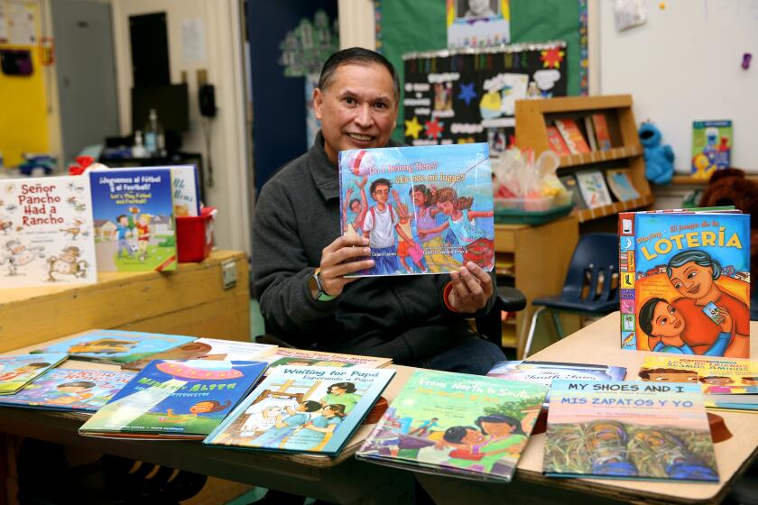 T-K teacher Rene Colato Lainez, 52, shows off the bilingual, English & Spanish, books he has written ov