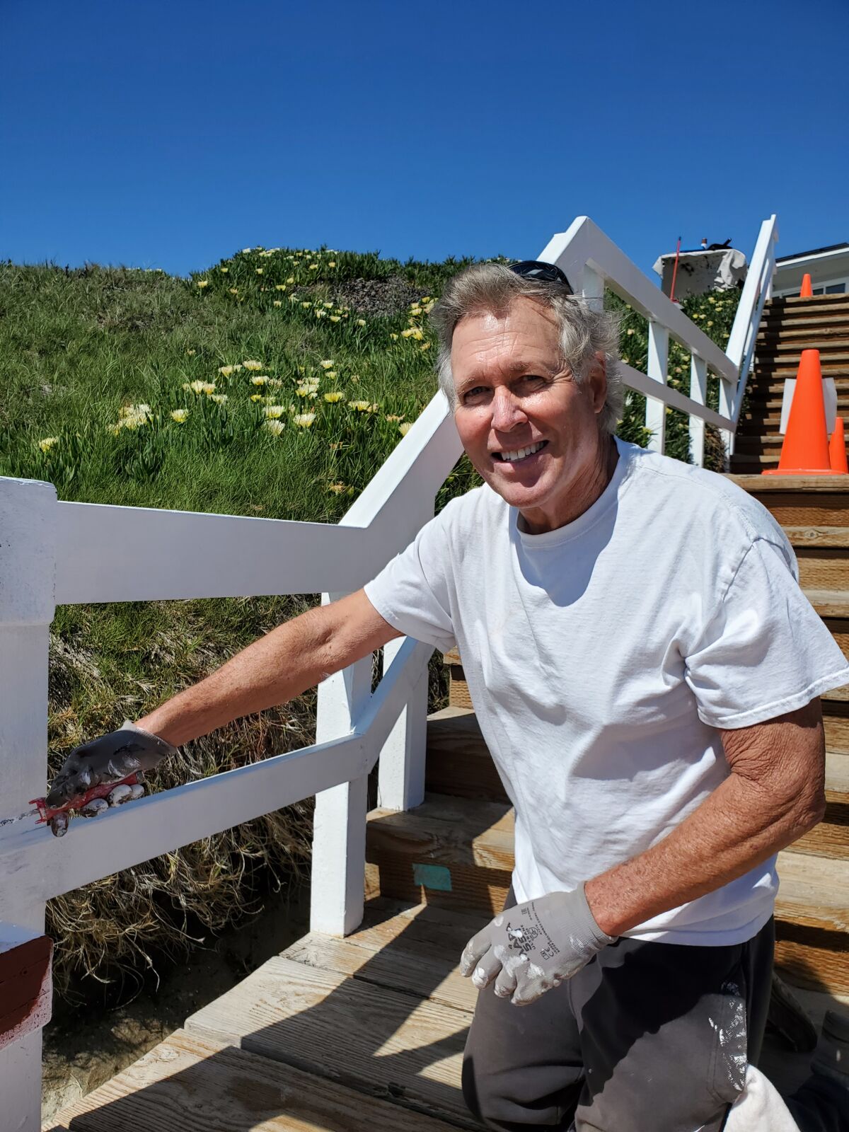 La Jolla resident and city of San Diego volunteer Joseph McGoldrick paints a stairway railing in Windansea.