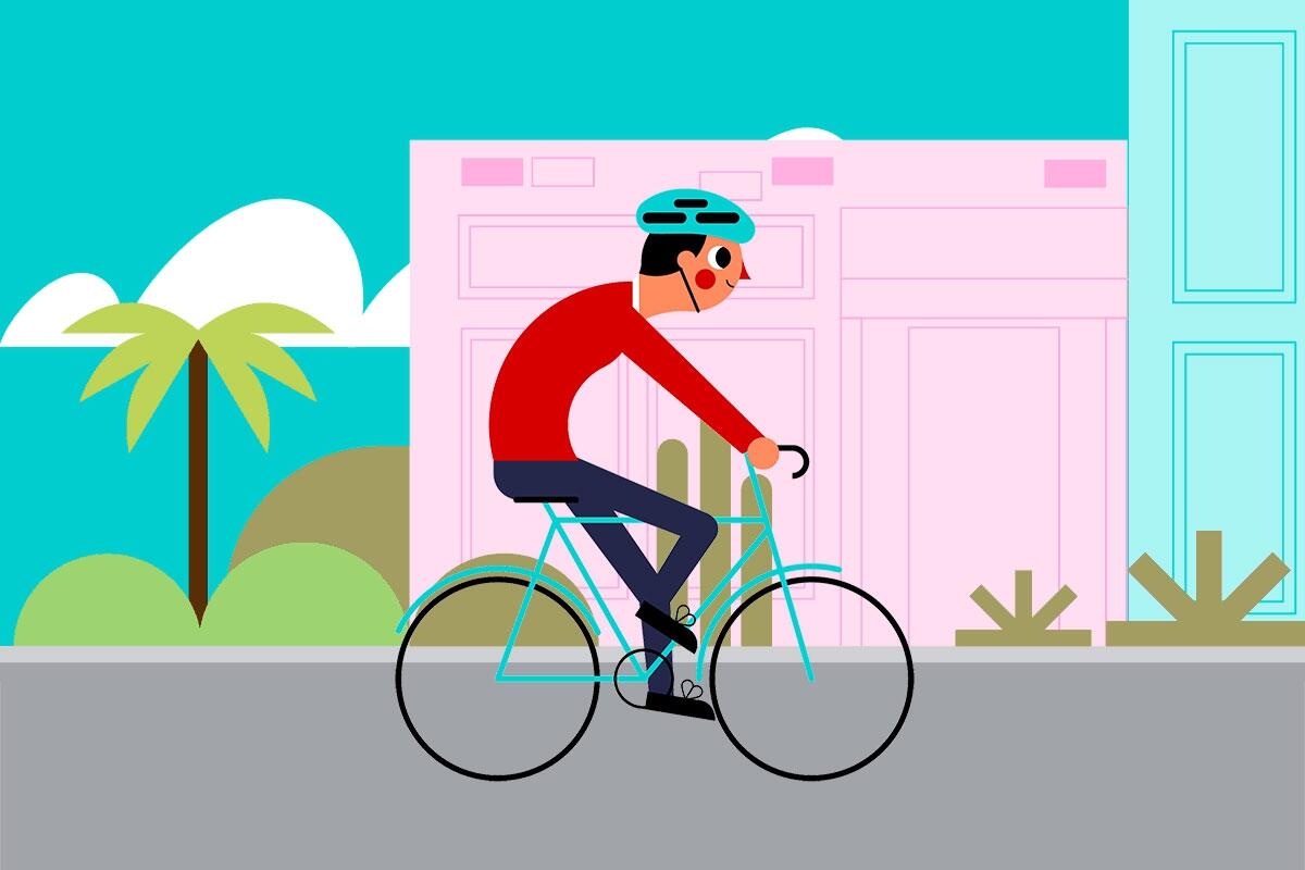 Man riding bike with buildings and palm trees in the background.