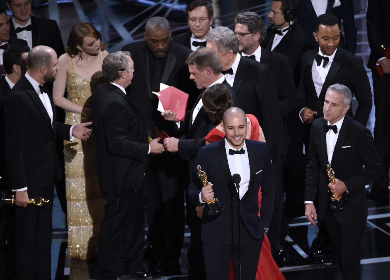 Fred Berger, foreground center, and the cast of "La La Land" mistakenly accept the award for best picture at the Oscars.