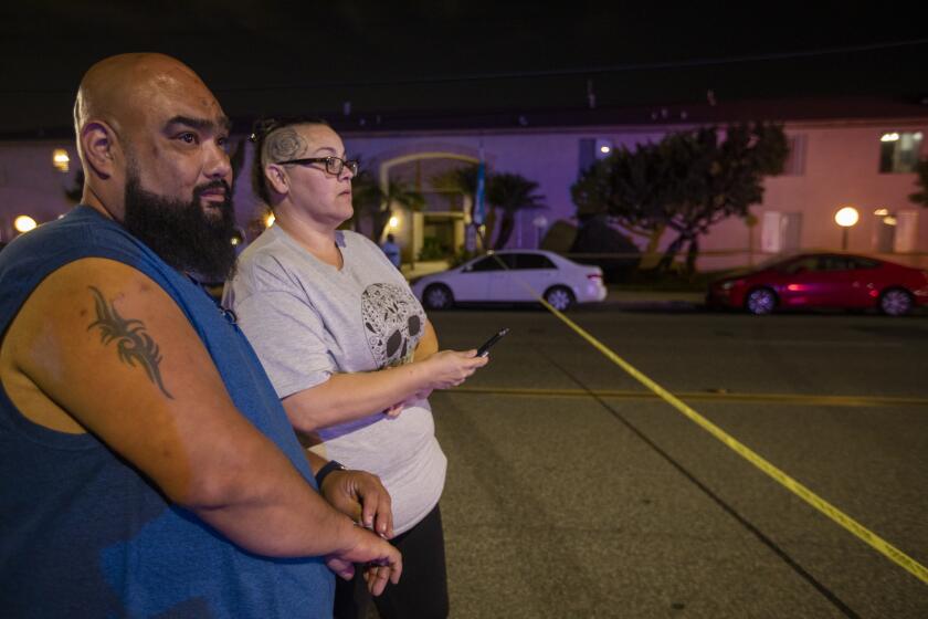 ORANGE, CA - MARCH 31: Four people, including a child, were killed Wednesday evening and a fifth person was injured in a mass shooting at an Orange office complex 0n Wednesday, March 31, 2021 in Orange, CA. Ray Rodriguez, 41, and his wife Jennifer Rodriguez, 39, live near by. They came out to check out to look around. They said they felt terribly a child was shot. (Francine Orr / Los Angeles Times)