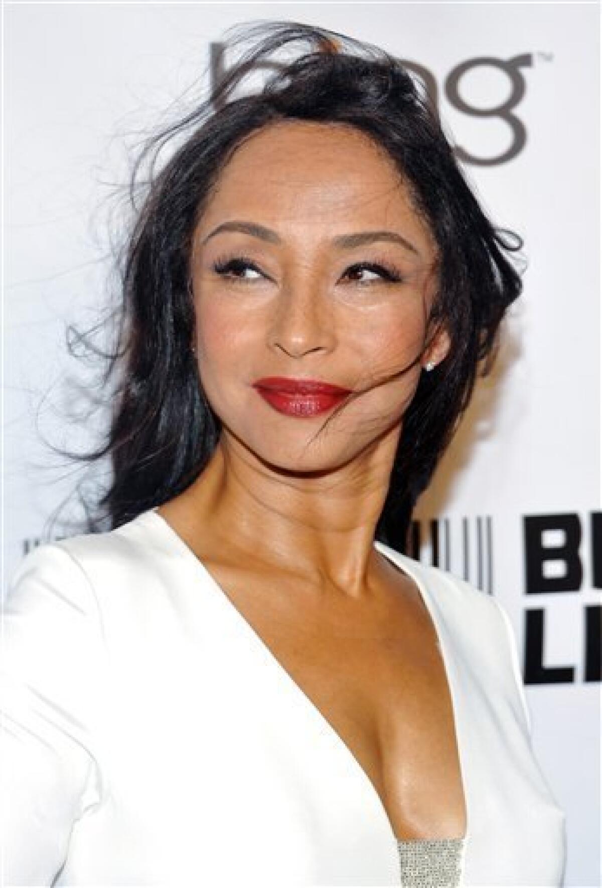 FILE - In this Sept. 30, 2010 file photo, singer Sade Adu arrives at the "Keep A Child Alive Black Ball" at the Hammerstein Ballroom in New York. When she decided to walk the red carpet at Alicia Keys' Black Ball for Keys' Keep a Child Alive charity it was a first for the enigmatic performer. (AP Photo/Evan Agostini, file)