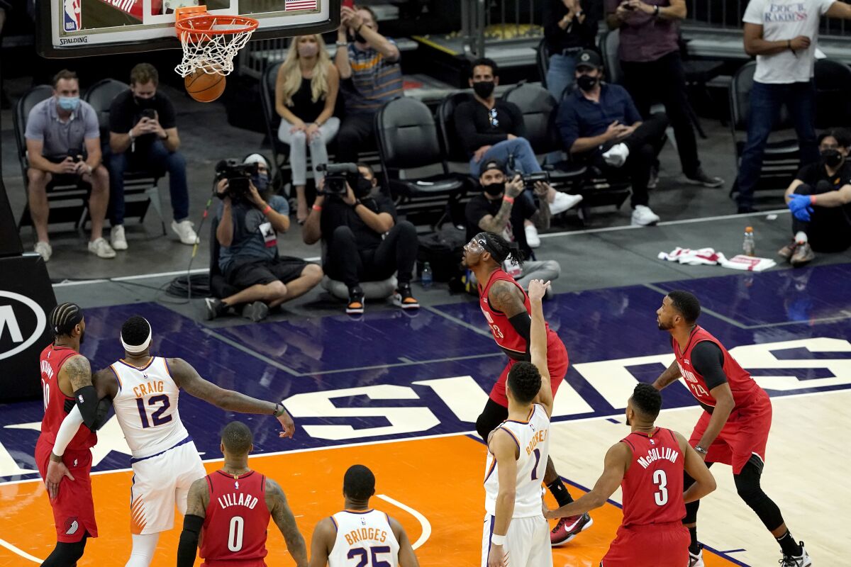 Phoenix Suns guard Devin Booker (1) makes the game winning free throw against the Portland Trail Blazers during the second half of an NBA basketball game, Thursday, May 13, 2021, in Phoenix. The Suns won 118-117. (AP Photo/Matt York)