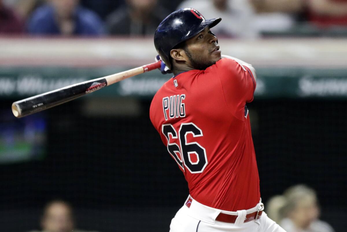 Cleveland Indians outfielder Yasiel Puig follows through on a swing.