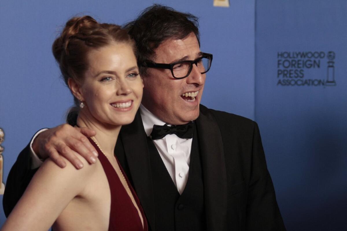 Director David O. Russell poses backstage at the Golden Globe Awards with Amy Adams. The two each came away with awards for "American Hustle."