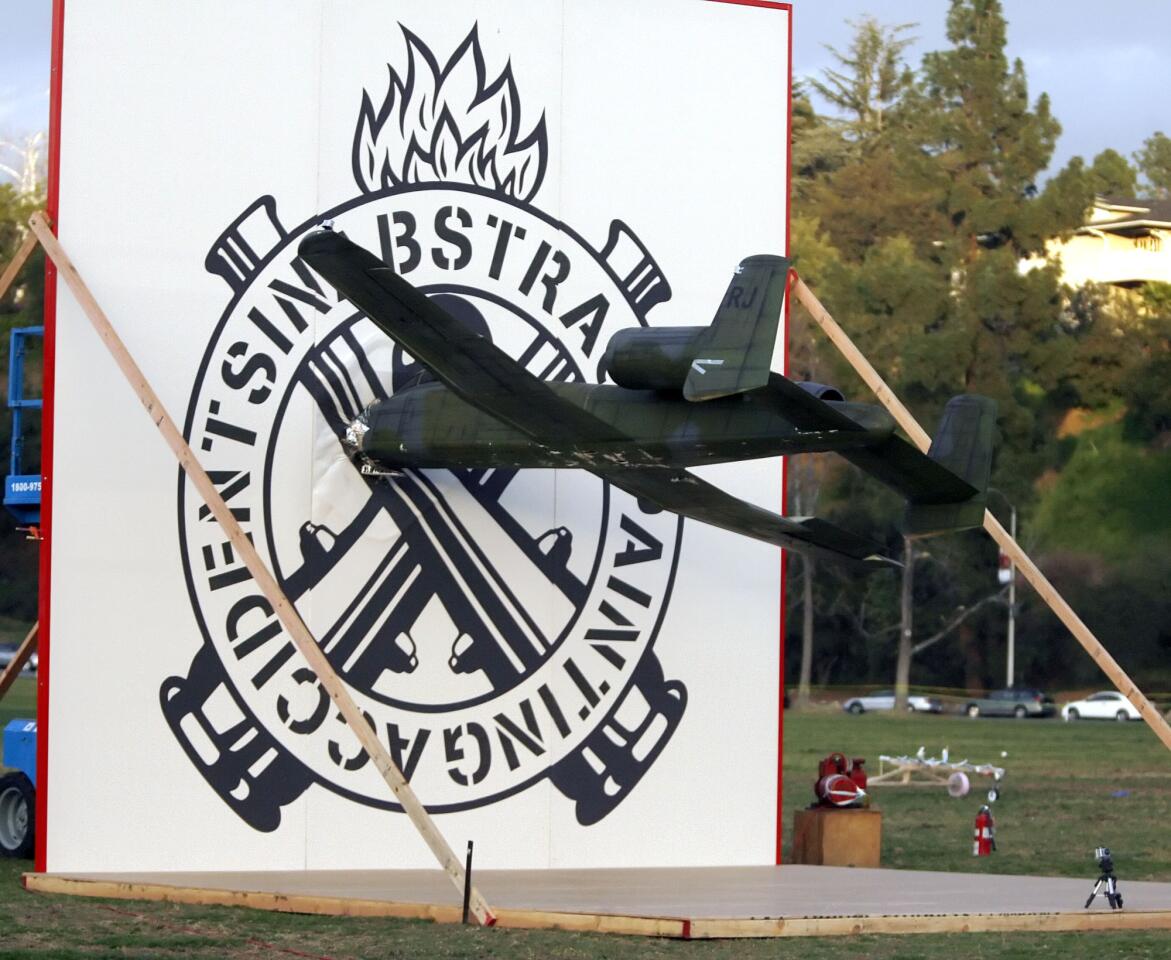 The moment of impact when a radio-controlled model A-10 military plane with a seventeen-foot wingspan, filled with paint, flew into a twenty-foot wall set up on the lawn south of the Rose Bowl in Pasadena on Saturday, January 22, 2012. Artist Richard Jackson's outdoor spectacle, Accidents in Abstract Painting Performance, drew a large crowd. The model plane was flown by Wyatt Sadler.