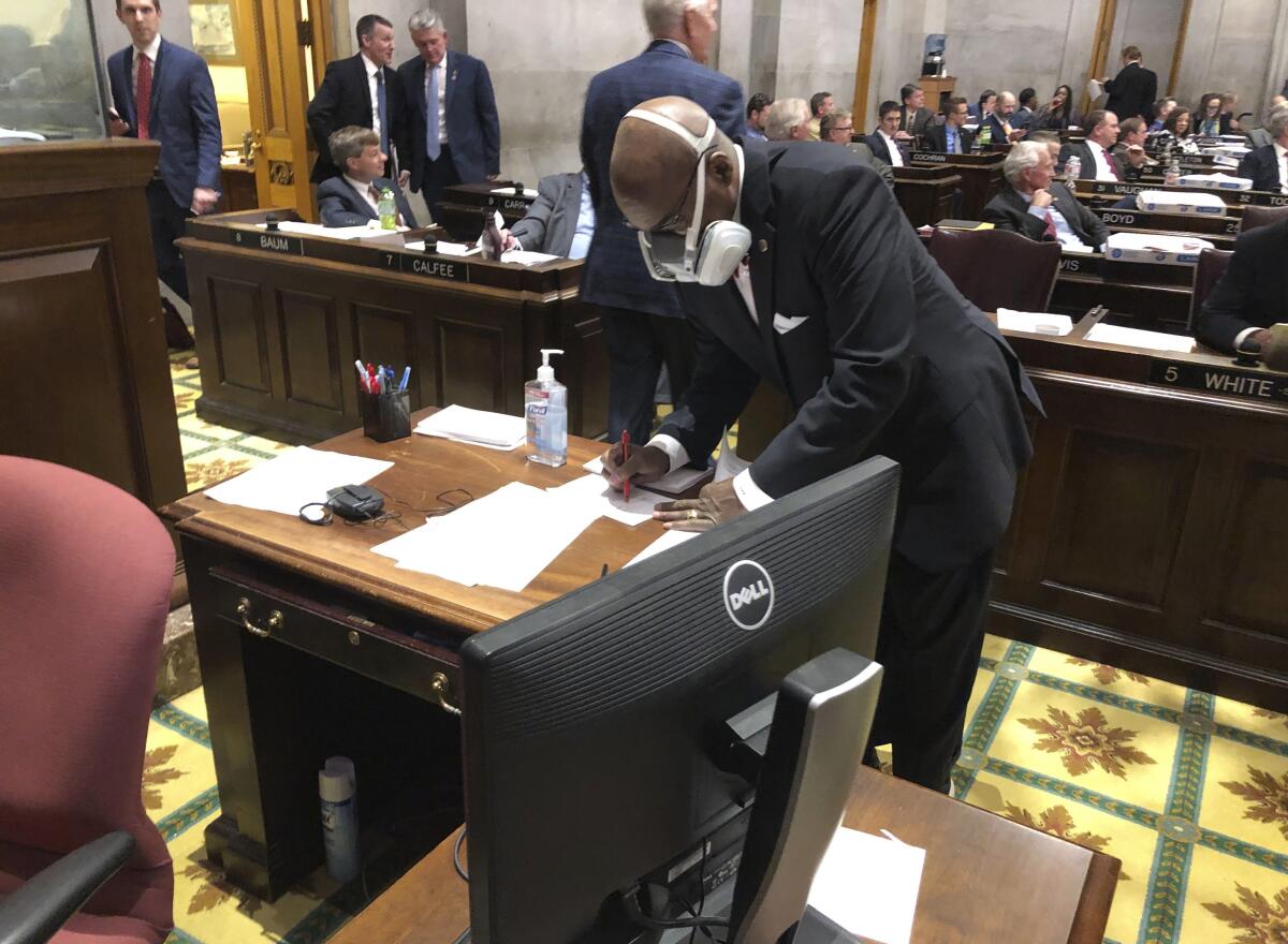 Tennessee State Rep. G.A. Hardaway wears a mask during legislative proceedings in Nashville in March. He is skeptical of the sharing of information with first responders about people who have tested positive for the coronavirus.