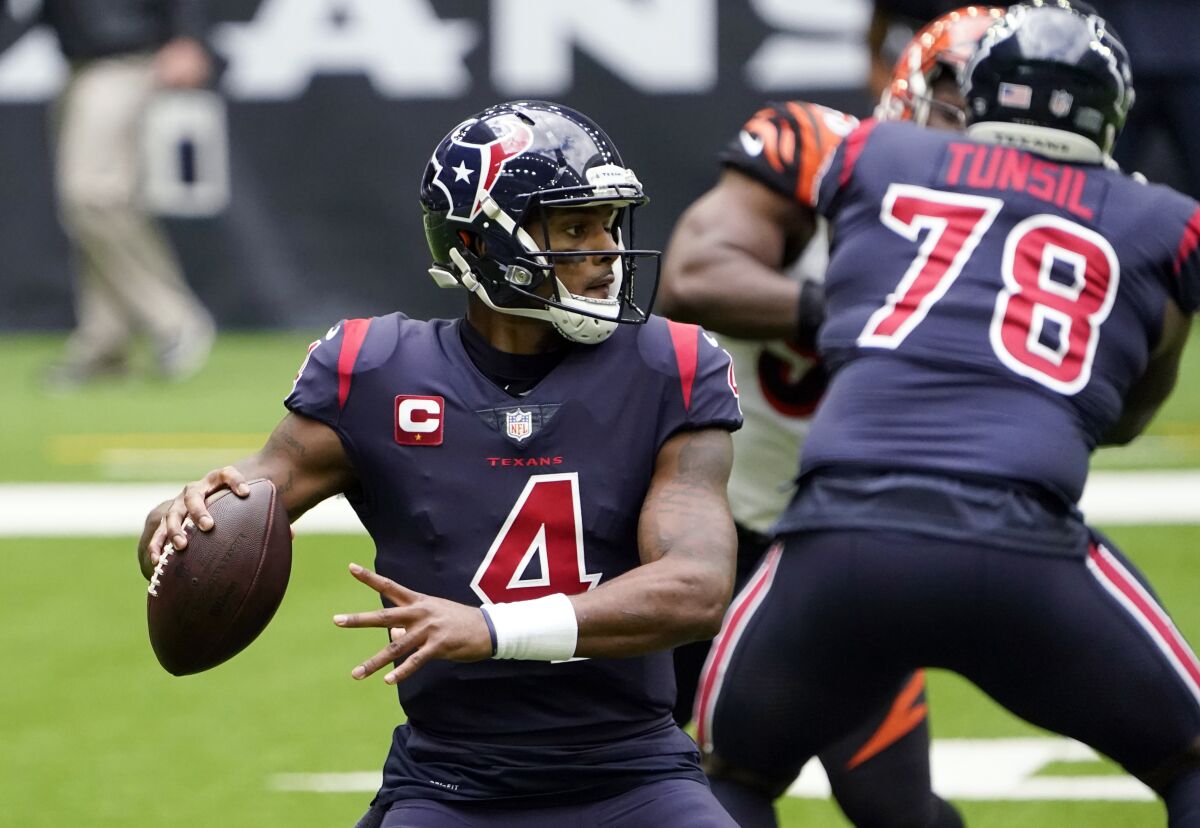 FILE -Houston Texans quarterback Deshaun Watson (4) looks for a receiver against the Cincinnati Bengals during the first half of an NFL football game Dec. 27, 2020, in Houston. The NFL trade deadline passed Tuesday, Nov. 2, with the Texans keeping the embattled quarterback on their roster. Watson has not played this season amid a trade request and 22 lawsuits alleging sexual harassment or assault. He has not been charged. (AP Photo/Sam Craft, File)