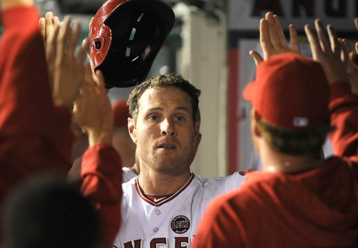Angels right fielder Josh Hamilton celebrates with teammates in the dugout after scoring in the seventh inning against the Chicago Cubs last Tuesday.