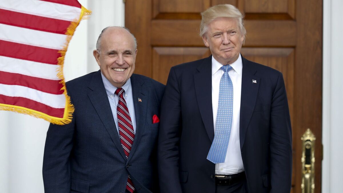 In this Nov. 20, 2016, photo, then-President-elect Trump, right, and former New York Mayor Rudy Giuliani as Giuliani arrives at the Trump National Golf Club Bedminster clubhouse in Bedminster, N.J.