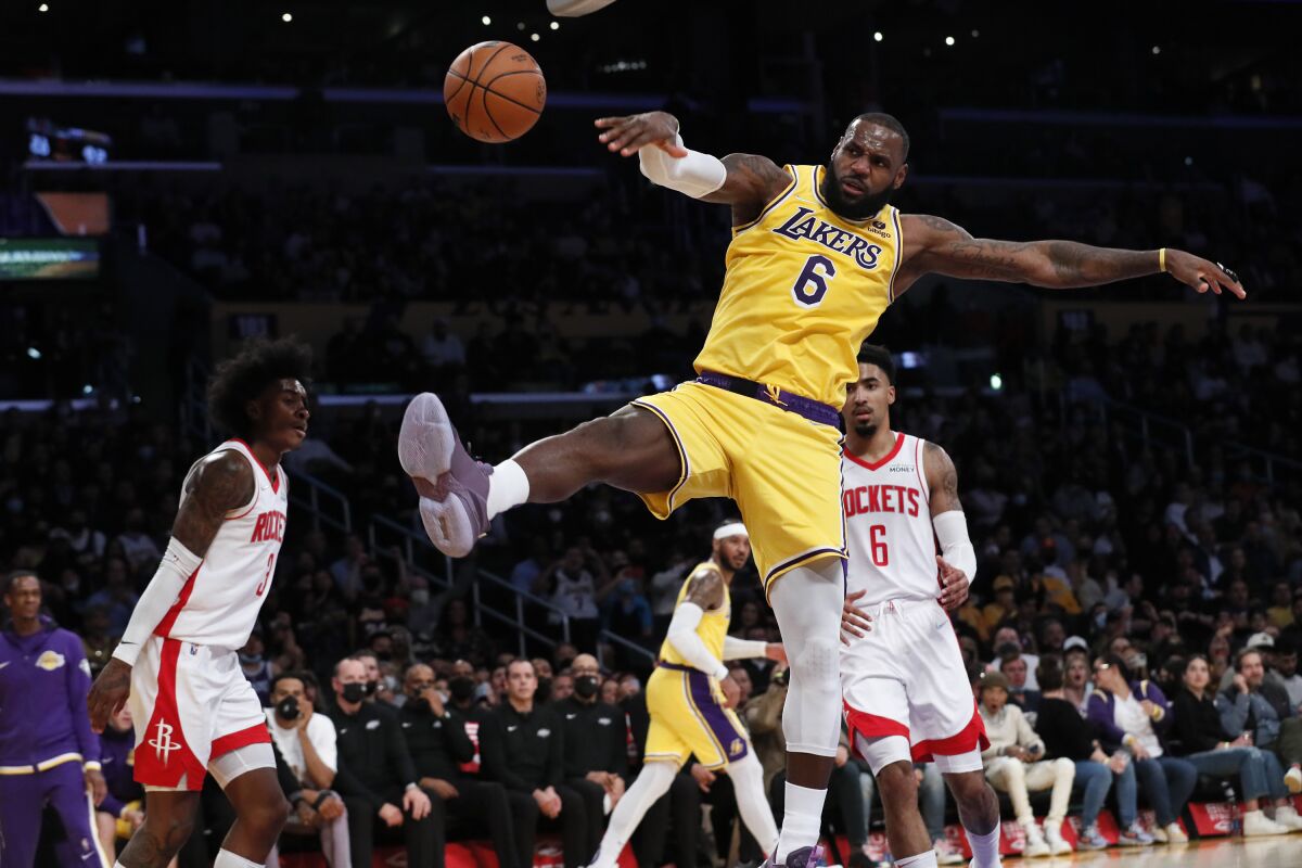 Lakers forward LeBron James follows through on a breakaway dunk against the Houston Rockets.