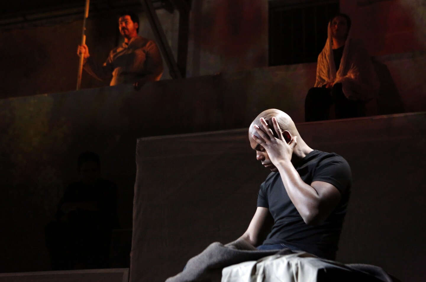 LaMarcus Miller, foreground, Zeffin Quinn Hollis, left, and Ani Maldjian perform a scene from the opera "Fallujah" at the Army National Guard in Long Beach.