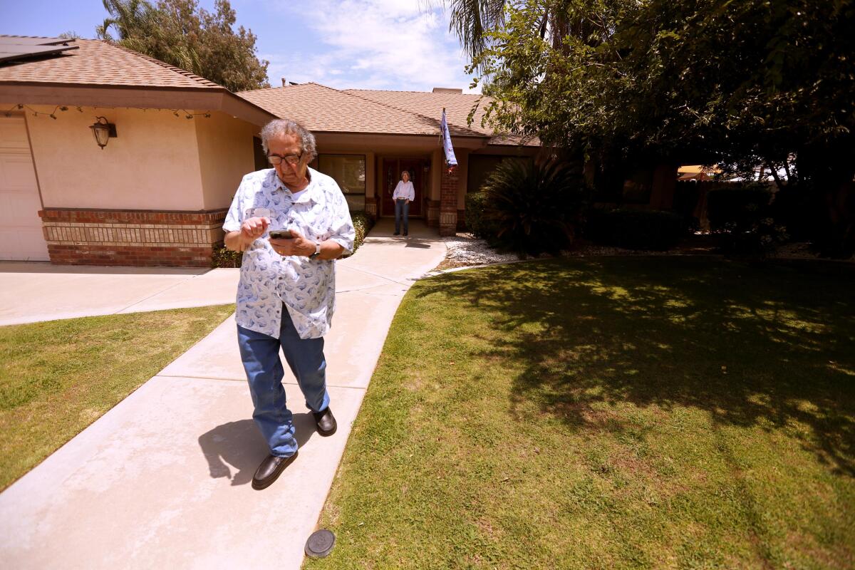 Ken Mattlin on his front walk. He can turn house lights off and on from his easy chair. 