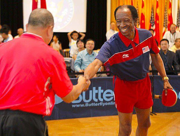 American player George Braithwaite greets Liang Geliang of China before their rematch on Thursday during the 40th anniversary celebration of their 1971 pingpong diplomacy meeting.