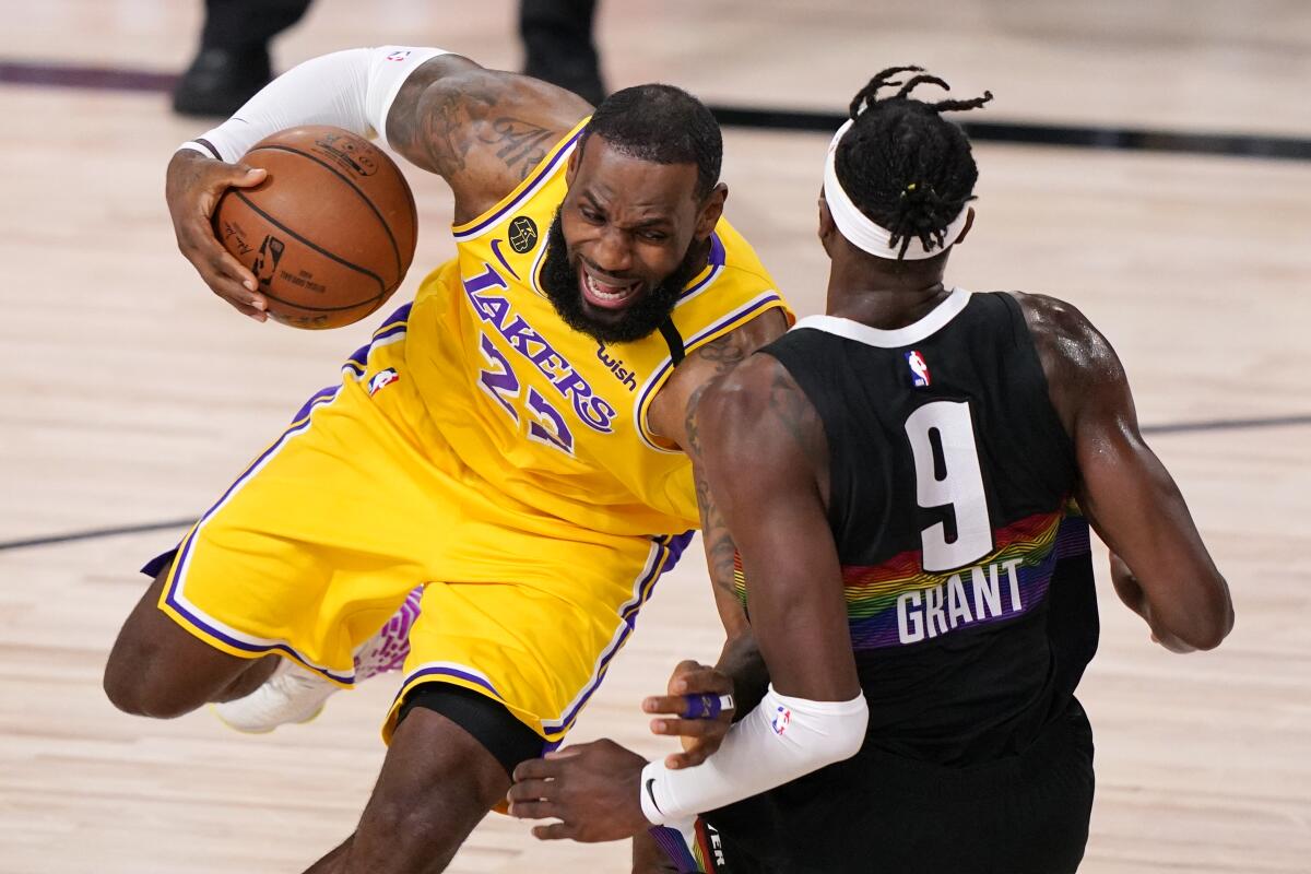 Lakers forward LeBron James draws a blocking foul against Nuggets forward Jerami Grant during Game 4.