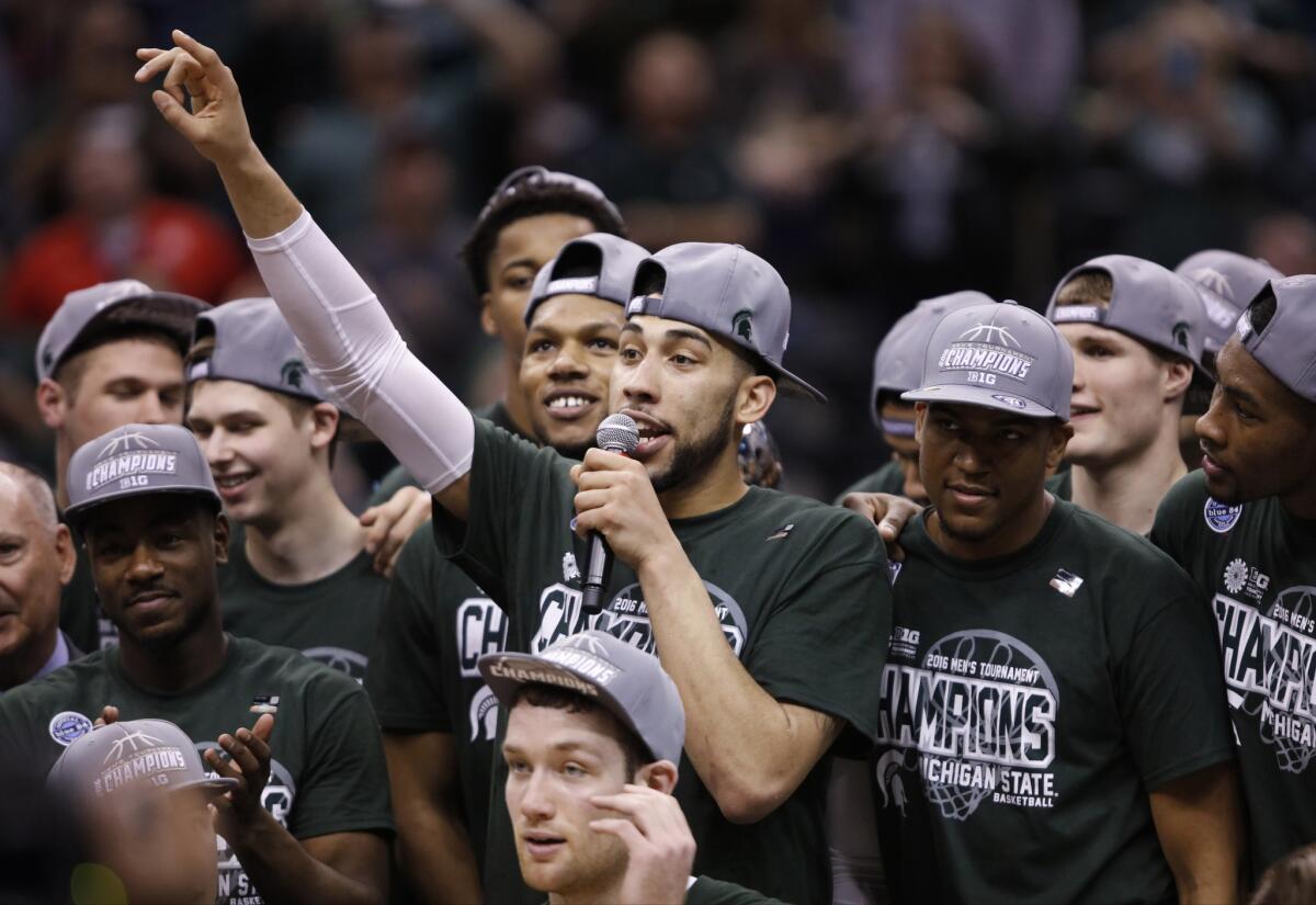 Michigan State forward Denzel Valentine (45) thanks fans as he celebrates with his teammates after winning the Big 10 conference tournament.