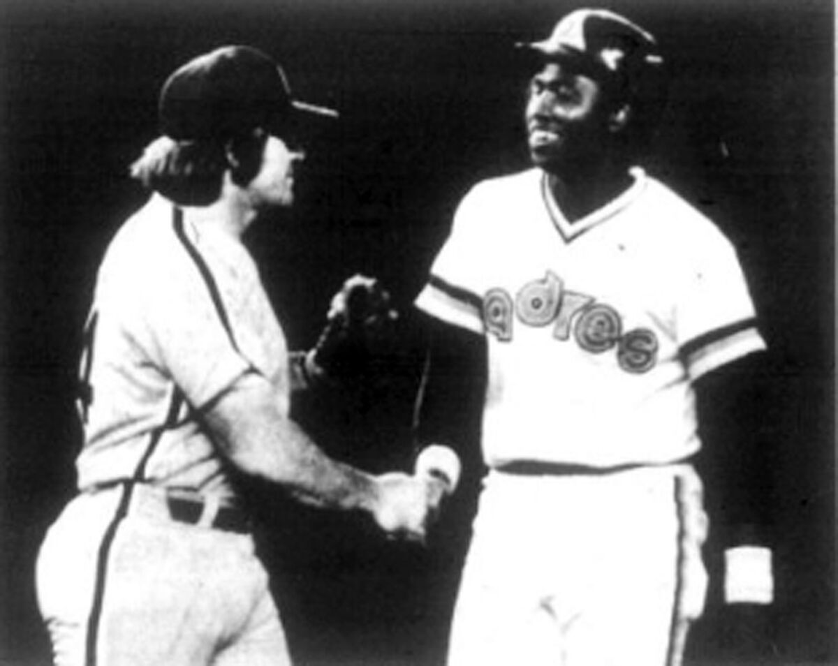 Phillies first baseman Pete Rose shakes hands with Tony Gwynn after  Gwynn's first major league hit, on July 19, 1982.