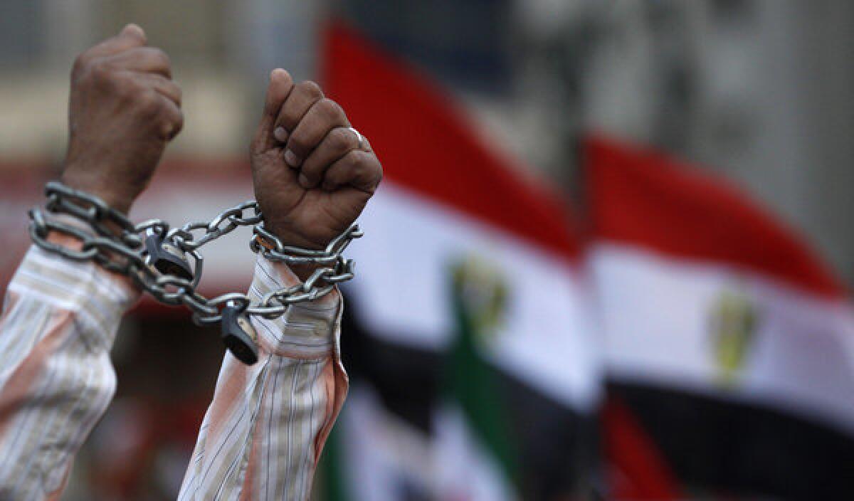 A protester in Cairo shows his chained hands during a demonstration against a proposed constitution.
