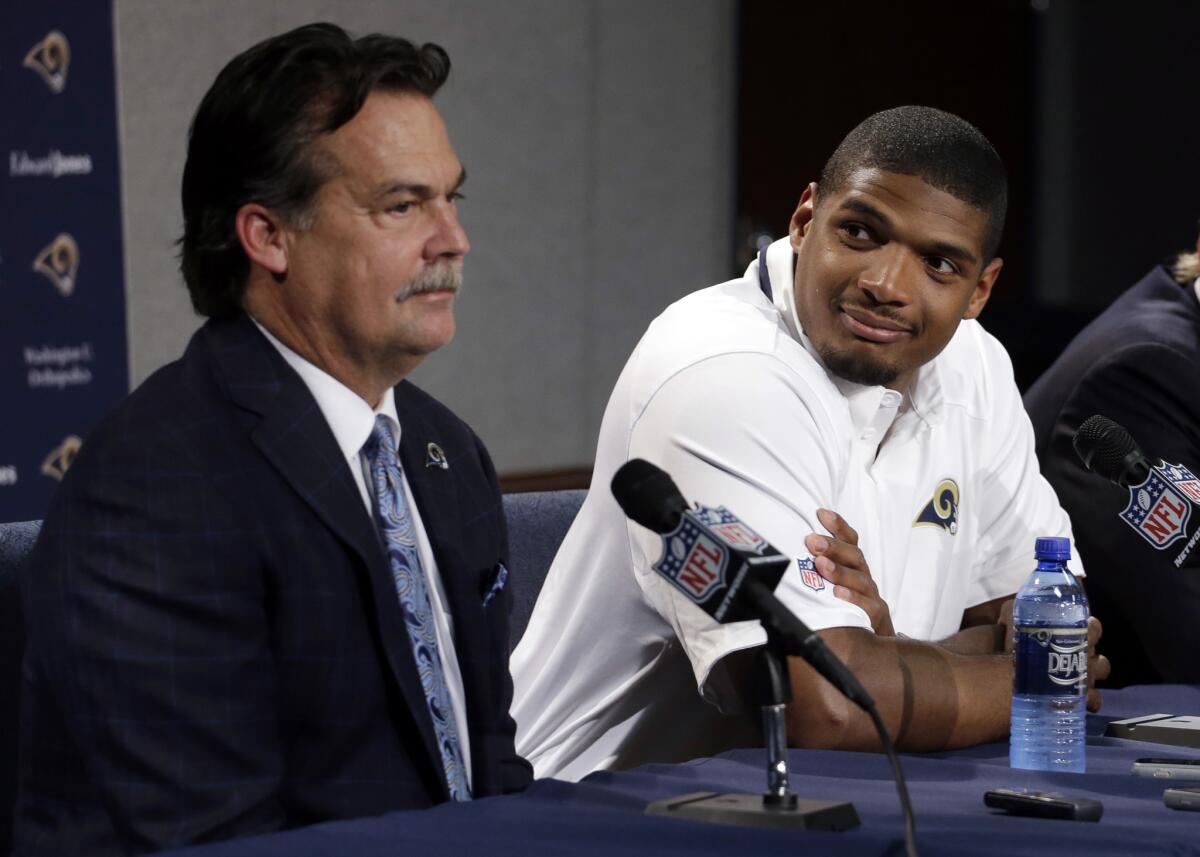Rams Coach Jeff Fisher, left, appears with player Michael Sam at a news conference on May 13, 2014.