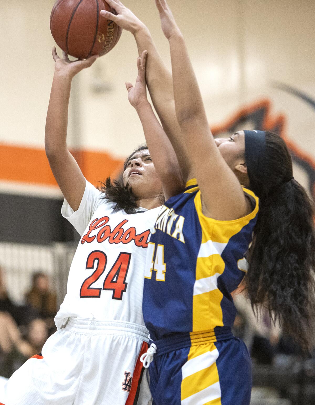 Los Amigos' Honey Morales goes up for a shot against La Quinta's Sylene Tavita during a Garden Grove League game on Friday.