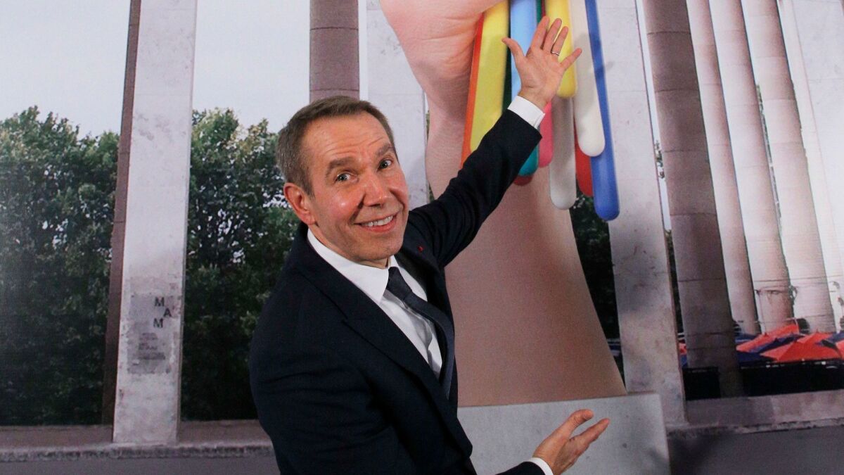 Jeff Koons poses next to the illustrations for his Paris sculpture "Bouquet of Tulips."