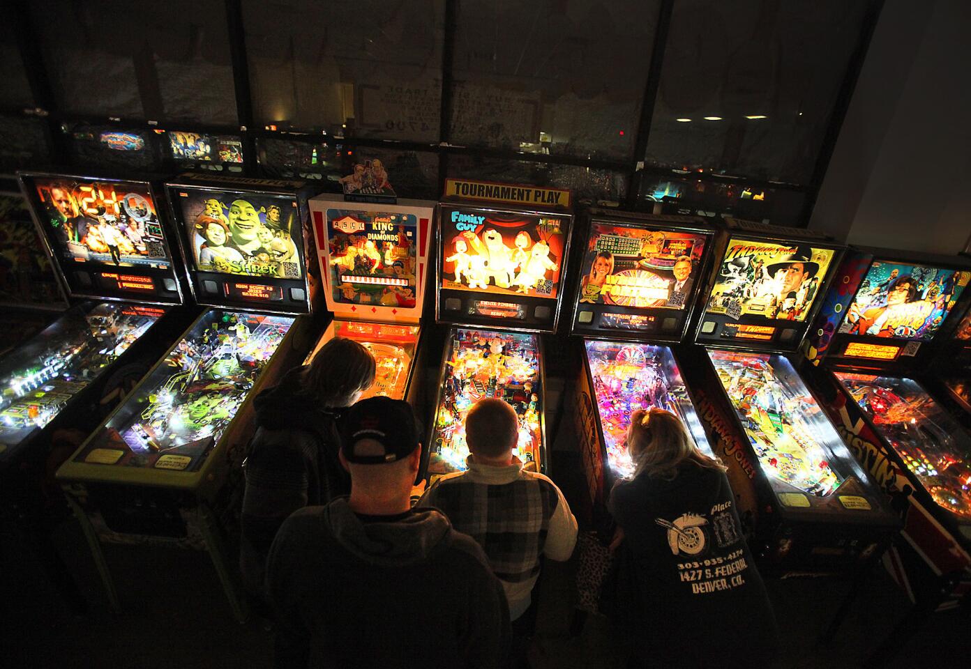 Vander Brug, Brian -- B581894168Z.1 LAS VEGAS, CA- February 15 2012: The heady family of Casper Wyoming gathers around Issac Heady, 12, as he plays pinball at the Pinball Hall of Fame in Las Vegas Wednesday February 15 2012. (Brian van der Brug/Los Angeles Times)