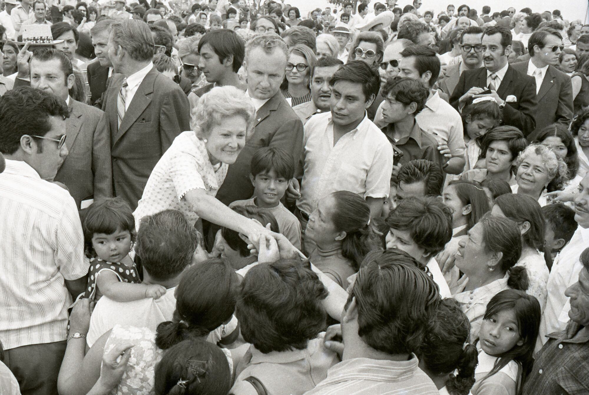 First Lady Pat Nixon greets Mexican children who had been clamoring for her attention 