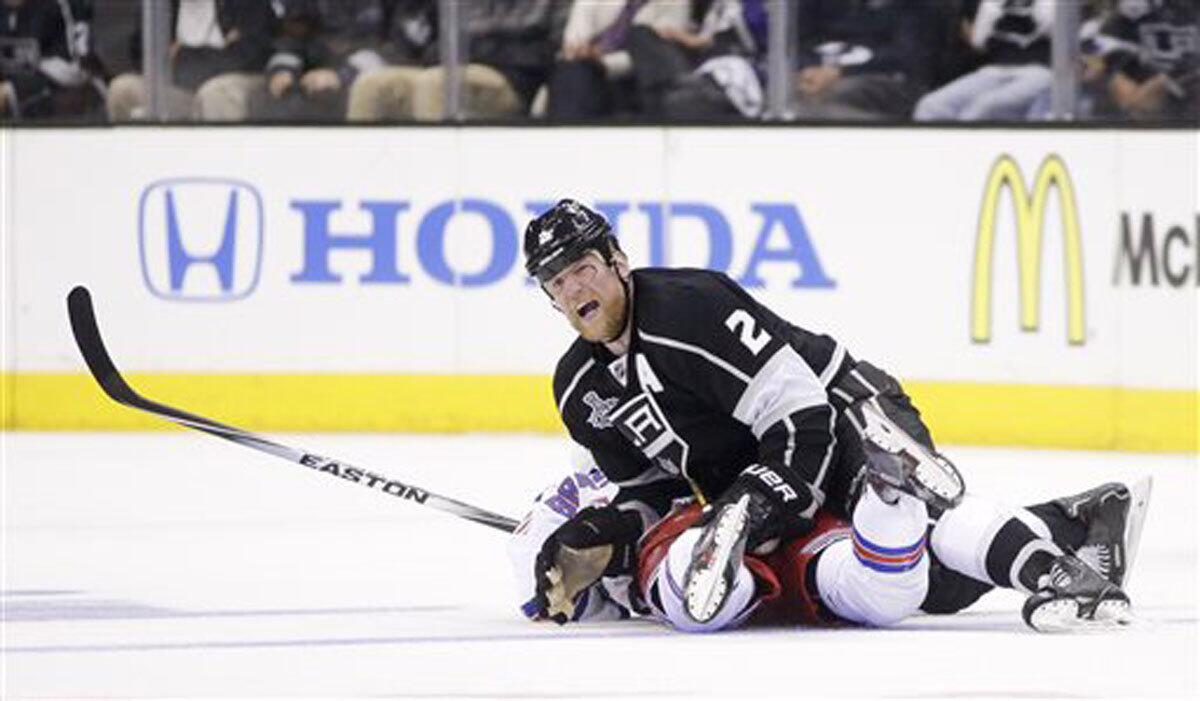 Matt Greene knocks New York Rangers center Derick Brassard to the ice in 2014.