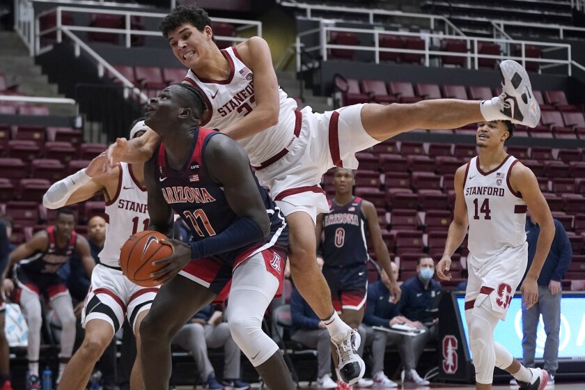Arizona center Oumar Ballo (11) is fouled by Stanford forward Brandon Angel, top, during the second half of an NCAA college basketball game in Stanford, Calif., Thursday, Jan. 20, 2022. (AP Photo/Jeff Chiu)