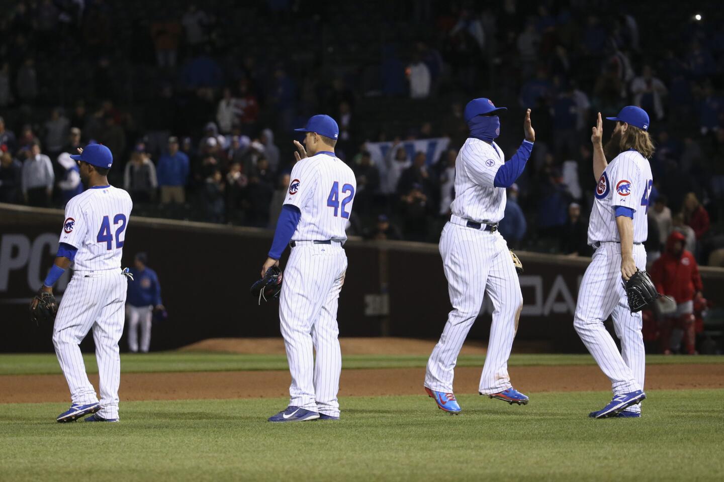 Cubs players celebrate after defeating the Reds 5-0 at Wrigley Field.