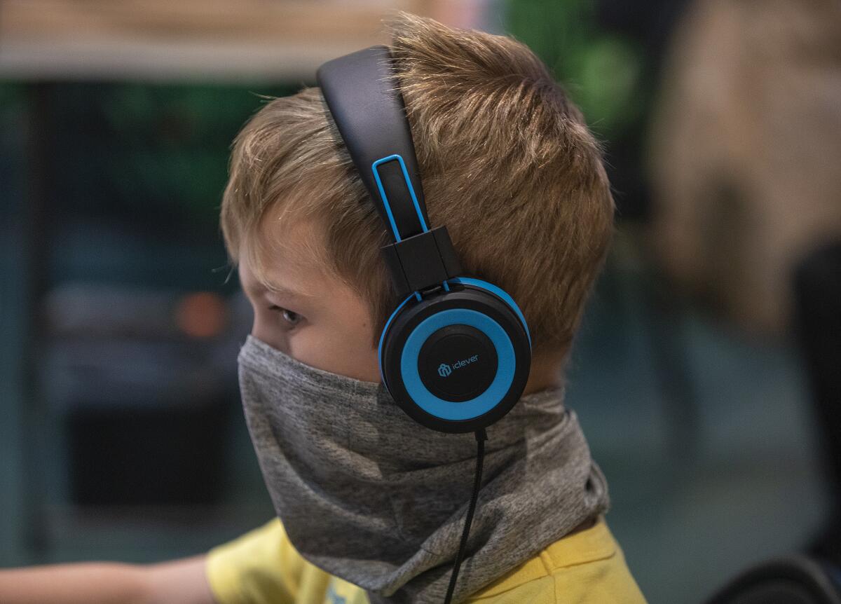 A first-grader participates in a class over Zoom on his first day of school in Culver City on Aug. 20.