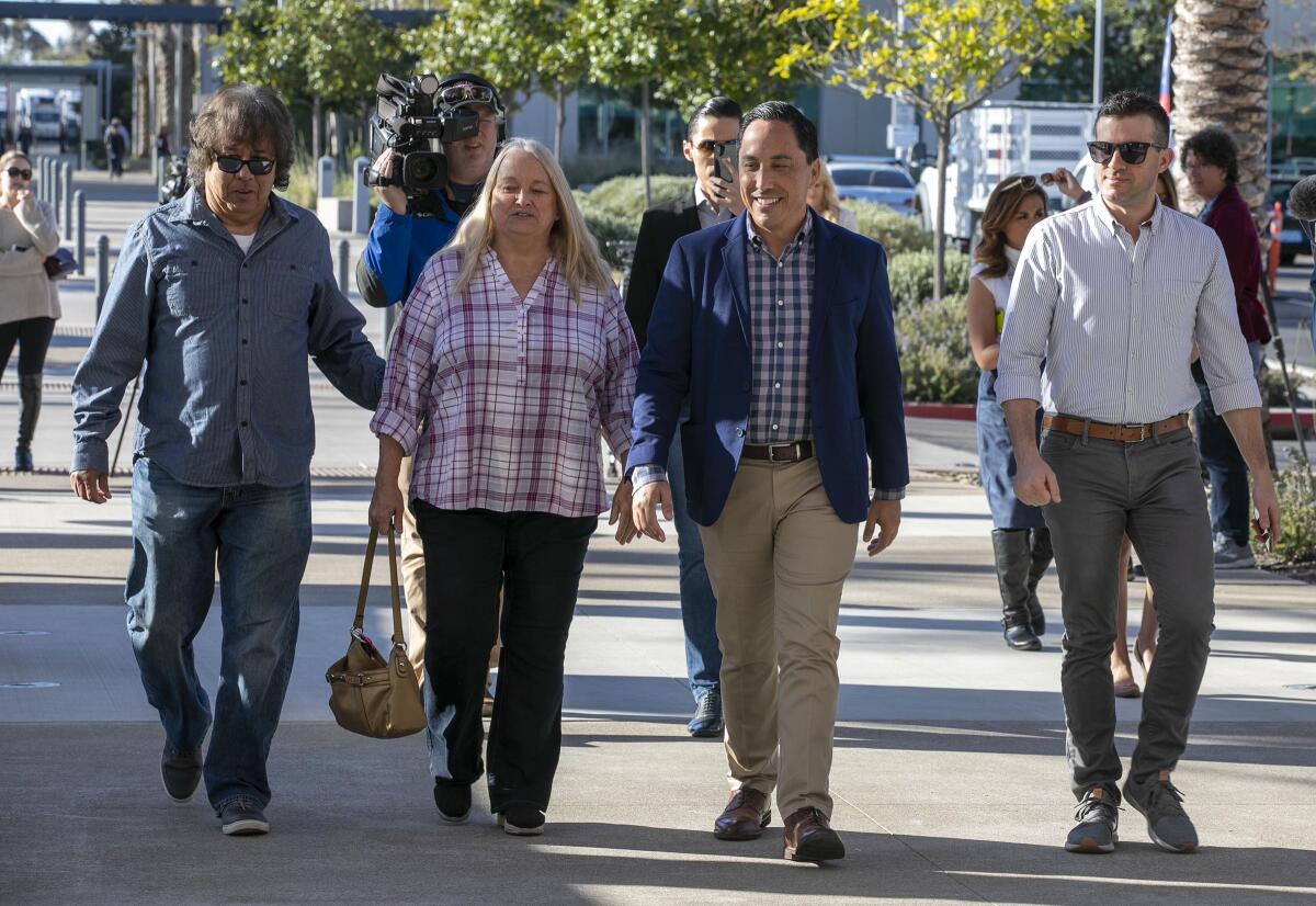 Todd Gloria, center, candidate for mayor, with his parents Linda and Phil Gloria , left, and his partner Adam Smith walked into the County Registrar of Voters office to vote on election day, Tuesday March 3, 2020.