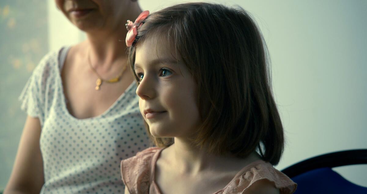 A little girl in with a butterfly barrette in the documentary “Little Girl.” 