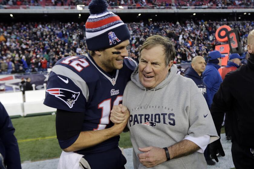 FILE - New England Patriots quarterback Tom Brady, left, celebrates with head coach Bill Belichick after defeating the Miami Dolphins 41-13 in an NFL football game Sunday, Dec. 14, 2014, in Foxborough, Mass. Tom Brady has retired after winning seven Super Bowls and setting numerous passing records in an unprecedented 22-year-career. He made the announcement, Tuesday, Feb. 1, 2022, in a long post on Instagram. (AP Photo/Charles Krupa, File)