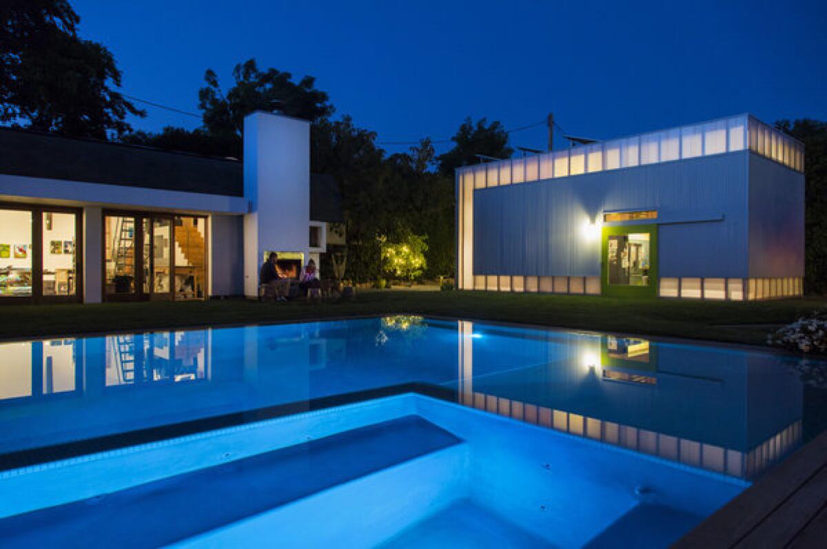 SOUTH PASADENA, CA - APRIL 18, 2013 - View of the swimming pool, art studio, Lt, Jamie and wife Anne-Elizabeth by fireplace and play house at the Sobieski's home, designed by Koning Eizenberg Architects, in South Pasadena, California, Thursday, April 18, 2013. The house was deconstructed into a miniature campus of individual rooms. (Ricardo DeAratanha/Los Angeles Times)