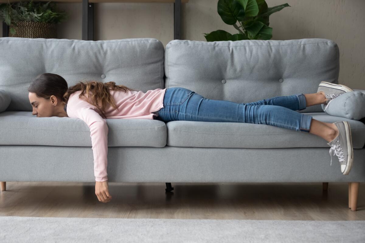 A girl naps on a sofa