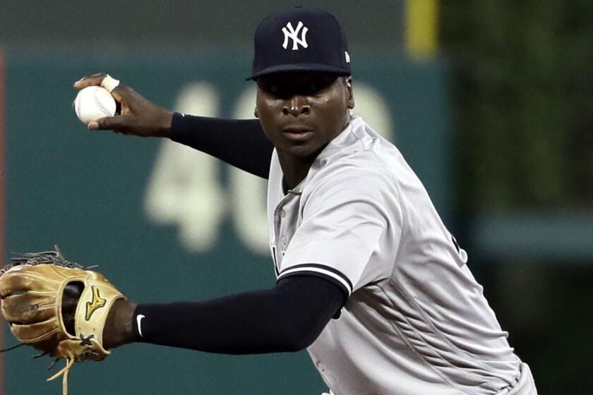 FILE - In this June 26, 2018, file photo, New York Yankees shortstop Didi Gregorius prepares to throw to first after fielding a ball during a baseball game against the Philadelphia Phillies in Philadelphia. The Yankees say star shortstop will need Tommy John surgery on his right elbow after injuring himself during the AL Division Series, the team announced Friday, Oct. 12, 2018. (AP Photo/Matt Slocum, File)