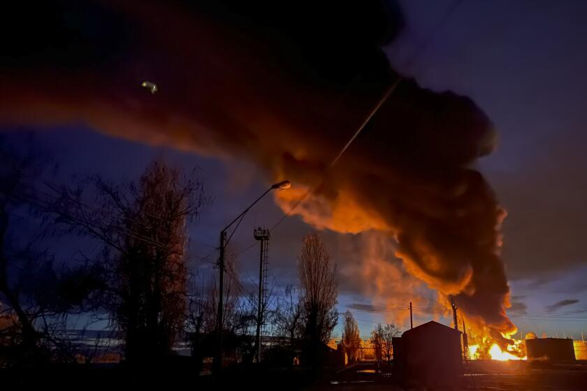 A plume of smoke rises during a fire caused by a Russian attack in Kherson, southern Ukraine, Saturday, Nov. 19, 2022. (AP Photo/Roman Hrytsyna)