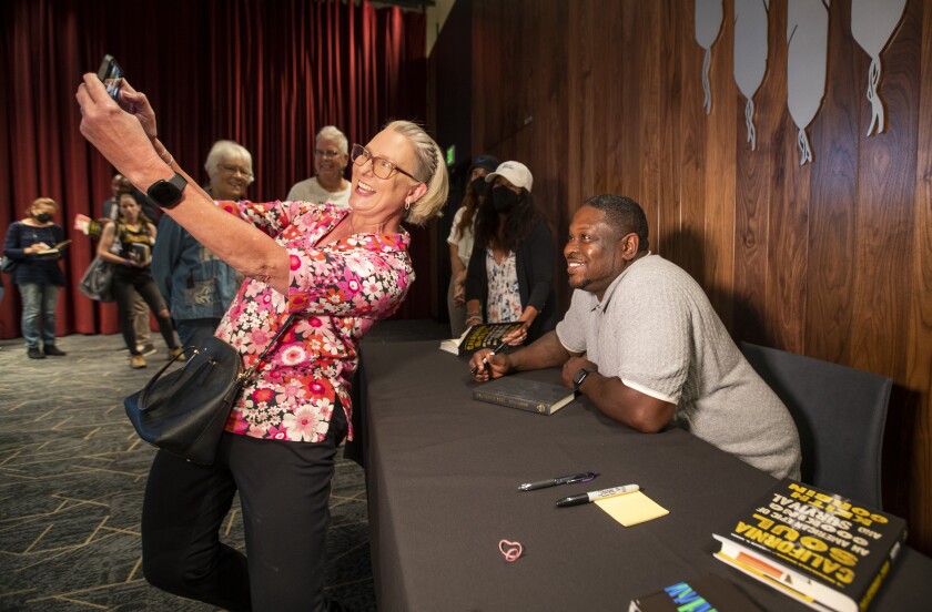 Wende Lee, of South Pasadena, takes a photo with chef Keith Corbin at the Los Angeles Times Book Club.