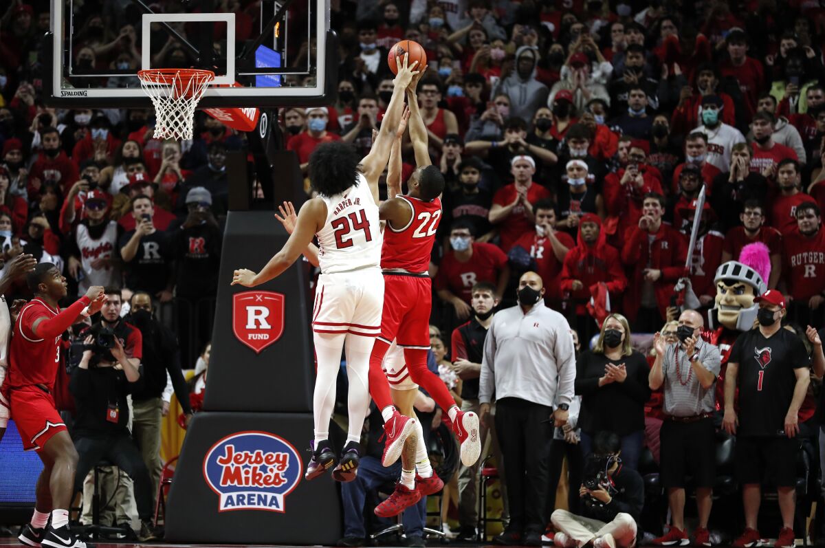 Rutgers guard Caleb McConnell (22) blocks the shot of Ohio State guard Malaki Branham (22) during the second half of an NCAA college basketball game in Piscataway, N.J., Wednesday, Feb. 9, 2022. Rutgers won 66-64. (AP Photo/Noah K. Murray)