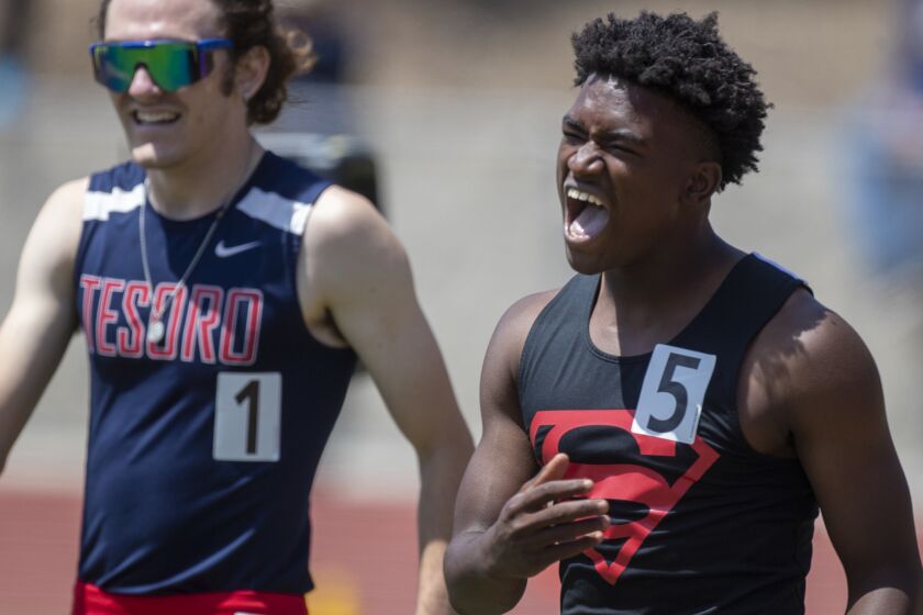 Moorpark, CA - May 21: Rodrick Pleasant of Gardena Serra High, right, yells after winning the 100 meters and a state record in 10.14 seconds at the Southern Section Masters Meet at Moorpark High School on Saturday, May 21, 2022 in Moorpark, CA. (Brian van der Brug / Los Angeles Times)