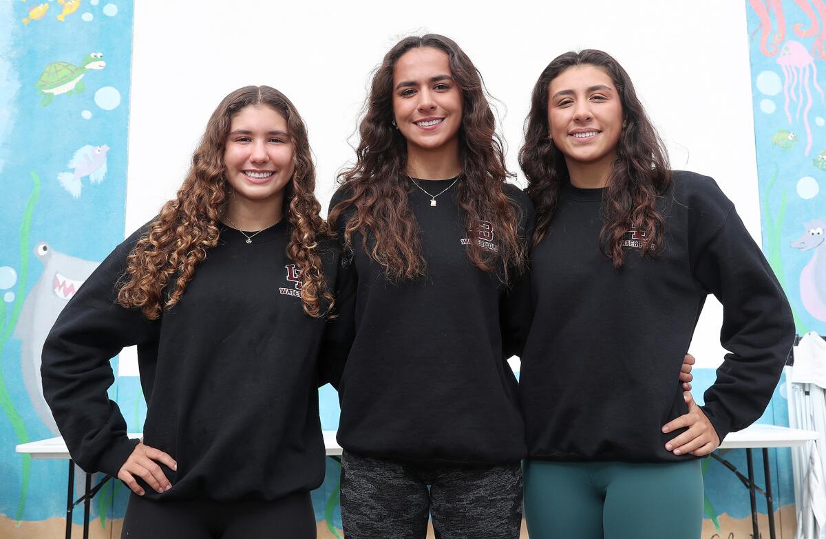 Brooke, Lauren and Jordan Schneider, from left, play for the Laguna Beach High girls' water polo team.