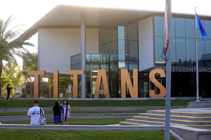 FULLERTON, CA - MAY 18: Graduating students pose in front of the Titan Student Union building on the campus of California State University, Fullerton (CSUF) on Thursday, May 18, 2023 in Fullerton, CA. Investigation accusing California State University, Fullerton President Framroze "Fram" Virjee of inappropriately touching students according to internal campus records. (Gary Coronado / Los Angeles Times)