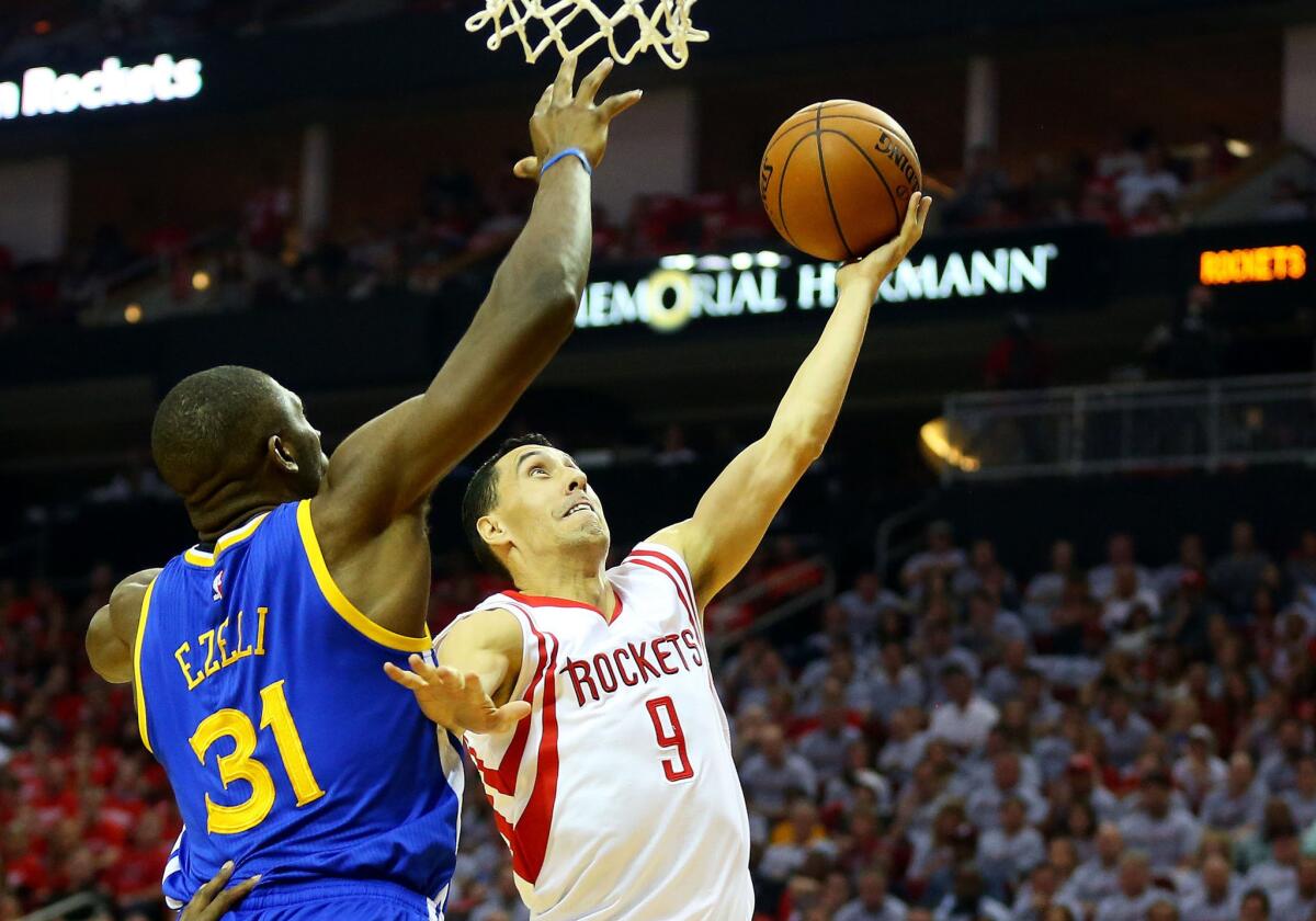 Pablo Prigioni, then with the Houston Rockets, attempts a layup against Golden State Warriors center Festus Ezeli during Game 3 of the Western Conference finals last season.